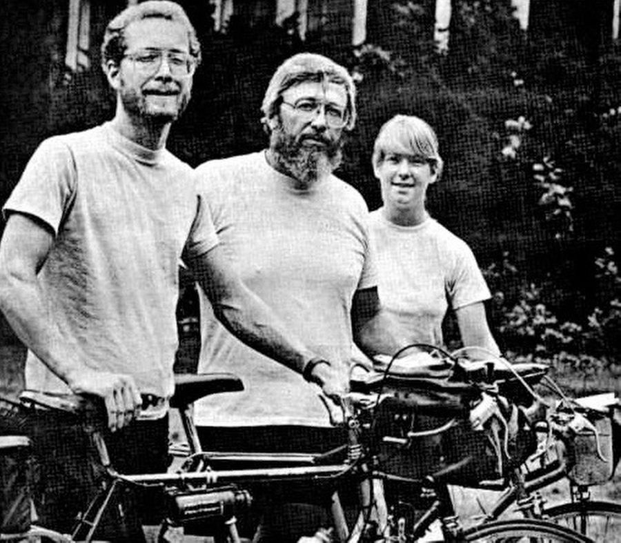 black and white photo of a father and his son and daughter with bicycles